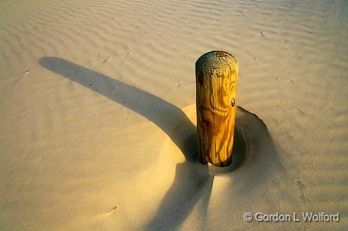 Disappearing Post_42298.jpg - A post about to be swallowed up by an encroaching sand dune.Photographed along the Gulf coast on Mustang Island near Corpus Christi, Texas, USA.